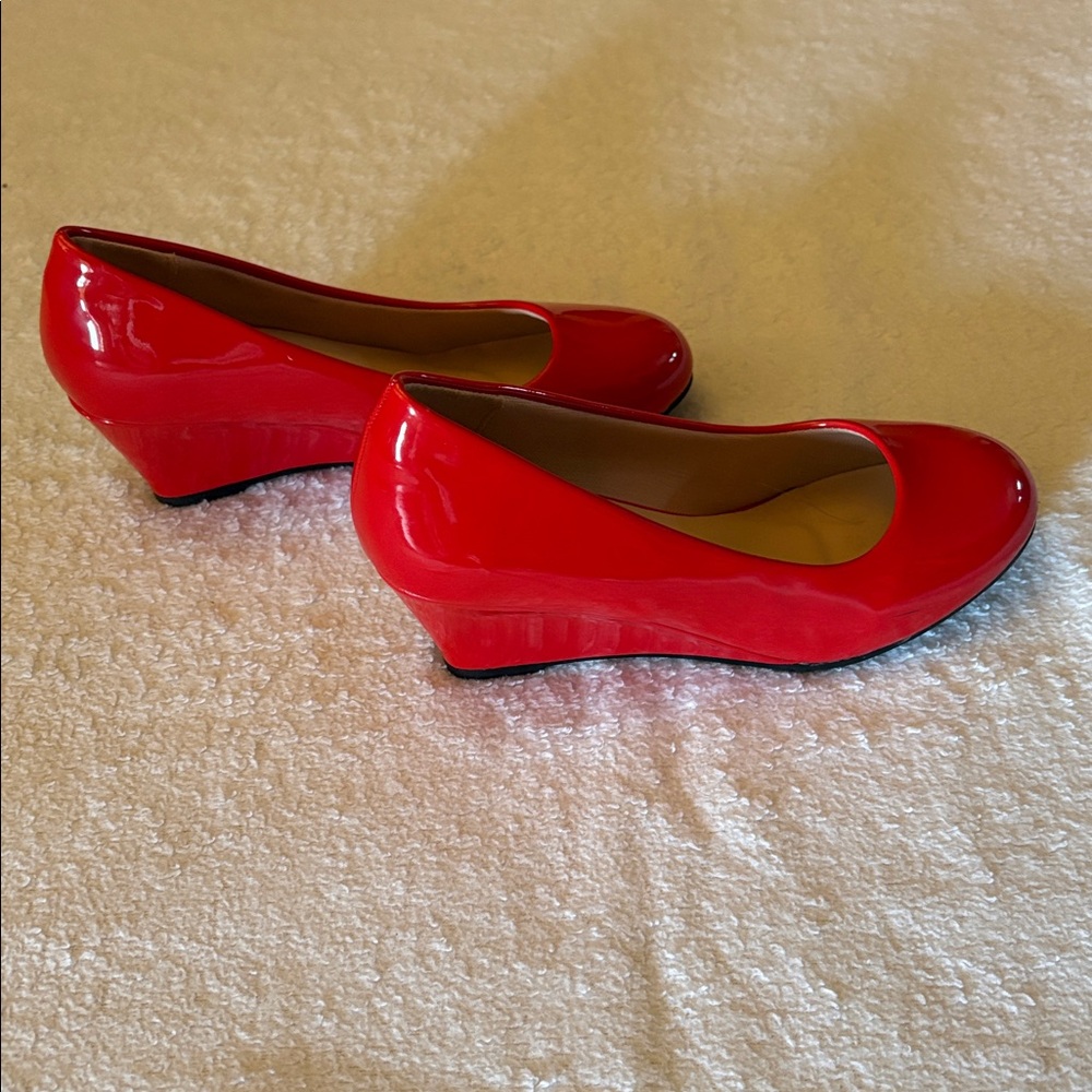 New. Never worn. Red Patent Leather Wedge Heels